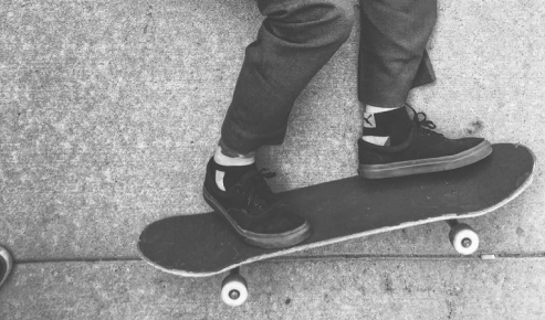 Another skateboarder, looking to the right.